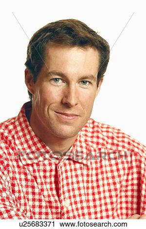 Stock Image - Portrait of a mid adult man smirking. Fotosearch
