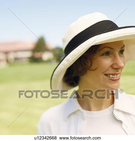 Stock Photo - Close-up of a mid adult woman smiling. Fotosearch