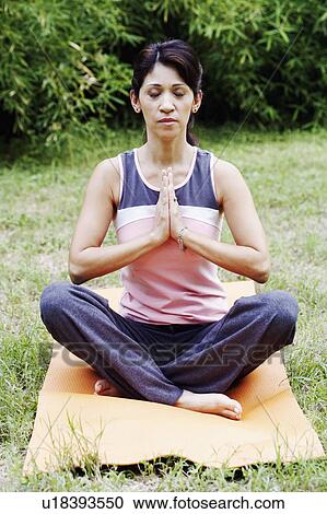 Mature woman doing yoga on the lawn View Large Photo Image Stock Image - Mature woman doing yoga on the lawn. Fotosearch