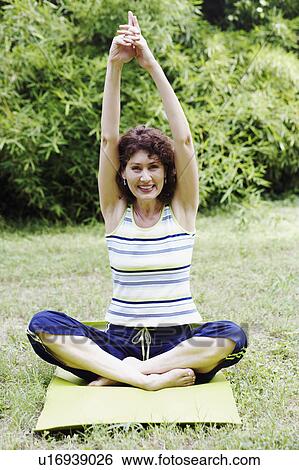 Mature woman exercising on the lawn View Large Photo Image Stock Photograph - Mature woman exercising on the lawn. Fotosearch