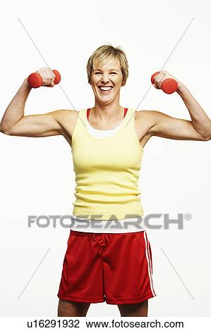 Portrait of a mature woman exercising with dumbbells and smiling View Large Photo Image Stock Image - Portrait of a mature woman exercising with dumbbells and smiling. Fotosearch