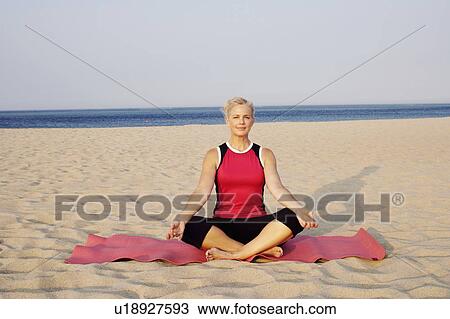 Portrait of a mature woman performing yoga on the beach View Large Photo Image Stock Image - Portrait of a mature woman performing yoga on the beach. Fotosearch