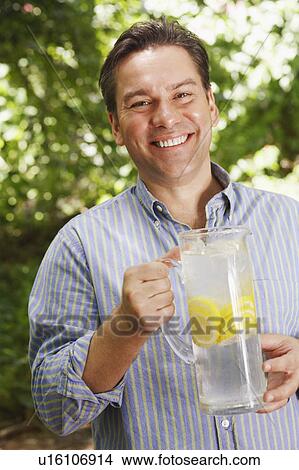 Picture - Portrait of a mature man holding a pitcher of lemonade. Fotosearch