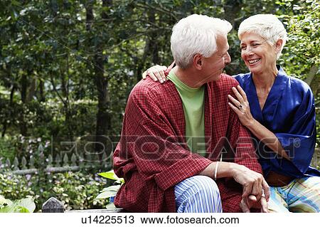 Close-up of a mature man and a senior woman looking at each other and smiling View Large Photo Image Stock Image - Close-up of a mature man and a senior woman looking at each other and smiling. Fotosearch