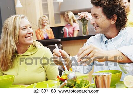 Close-up of a mature man with a mature woman sitting at the dining table View Large Photo Image Stock Photo - Close-up of a mature man with a mature woman sitting at the dining table. Fotosearch