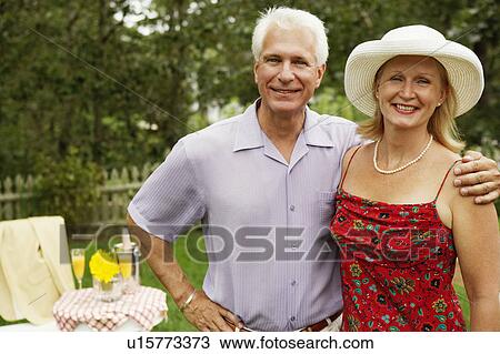 Portrait of a mature couple standing together View Large Photo Image Stock Image - Portrait of a mature couple standing together. Fotosearch