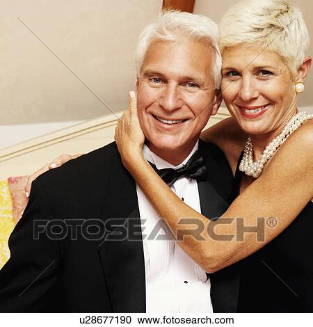 Stock Image - Portrait of a senior woman embracing a mature man and smiling. Fotosearch