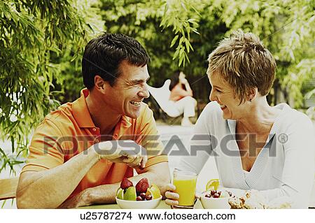 Close-up of a mature couple having breakfast View Large Photo Image Picture - Close-up of a mature couple having breakfast. Fotosearch