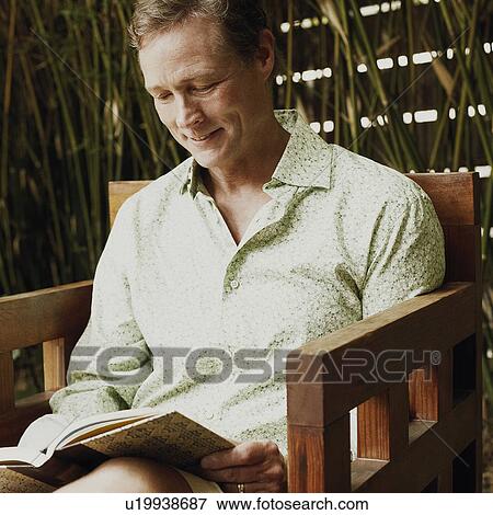 Close-up of a mature man reading a book View Large Photo Image Stock Photo - Close-up of a mature man reading a book. Fotosearch