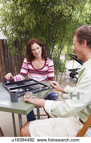 Mature couple playing backgammon View Large Photo Image Stock Image - Mature couple playing backgammon. Fotosearch