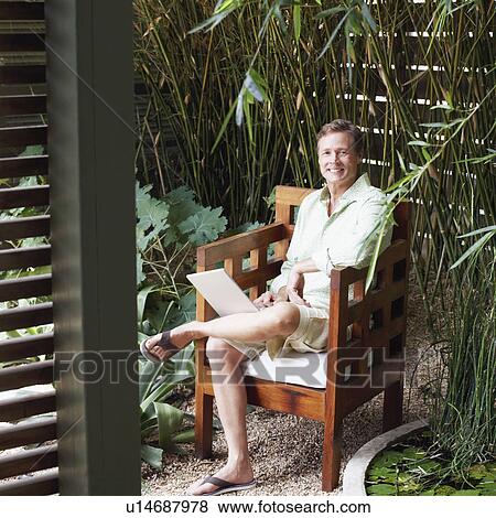 Stock Photo - Portrait of a mature man working on a laptop. Fotosearch