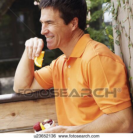 Side profile of a mature man holding a bowl of fruit View Large Photo Image Stock Photograph - Side profile of a mature man holding a bowl of fruit. Fotosearch