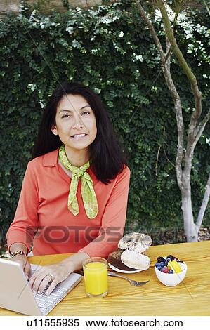 Stock Photography - Portrait of a mature woman working on a laptop. Fotosearch