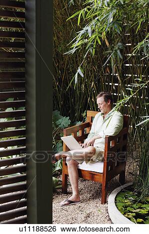 Stock Photograph - Side profile of a mature man working on a laptop. Fotosearch