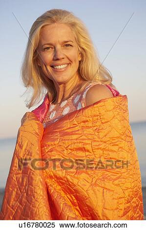 Portrait of a mature man wrapped in a blanket and smiling View Large Photo Image Stock Photography - Portrait of a mature man wrapped in a blanket and smiling. Fotosearch