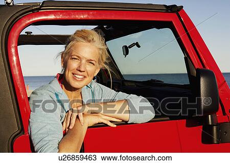 Portrait of a mature woman leaning against the vehicle door View Large Photo Image Stock Image - Portrait of a mature woman leaning against the vehicle door. Fotosearch