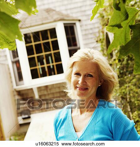 Stock Photography - Portrait of a mature woman smiling. Fotosearch