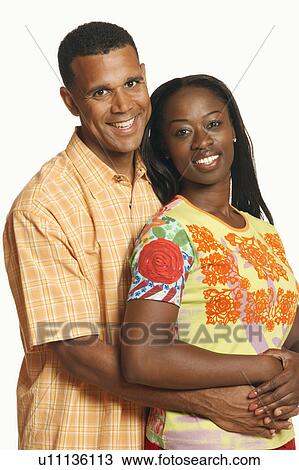 Portrait of a mature man embracing a mid adult woman from behind View Large Photo Image Stock Image - Portrait of a mature man embracing a mid adult woman from behind. Fotosearch