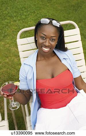 Portrait of a mid adult woman holding a martini glass View Large Photo Image Stock Photography - Portrait of a mid adult woman holding a martini glass. Fotosearch