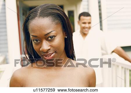 Portrait of a mid adult woman with a mature man standing behind her View Large Photo Image Stock Photo - Portrait of a mid adult woman with a mature man standing behind her. Fotosearch