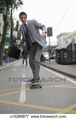 Business man on skateboard View Large Photo Image Stock Photo - Business man on skateboard. Fotosearch