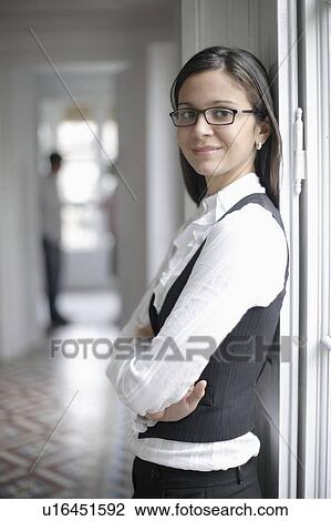 Business woman standing by window View Large Photo Image Stock Image - Business woman standing by window. Fotosearch