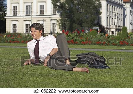 Businessman on square sitting in meadow laughing. View Large Photo Image Stock Image - Businessman on square sitting in meadow laughing.. Fotosearch