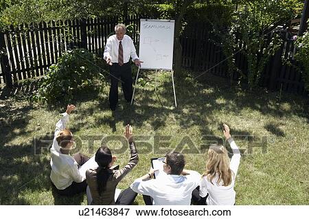 Businesspeople at a rural retreat. View Large Photo Image Stock Photo - Businesspeople at a rural retreat.. Fotosearch
