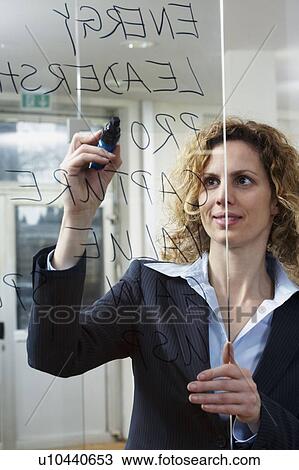 Businesswoman writing keywords on glass View Large Photo Image Stock Image - Businesswoman writing keywords on glass. Fotosearch