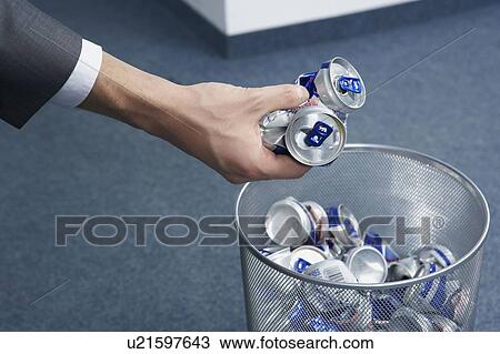 Stock Image - Cans being placed into bin. Fotosearch