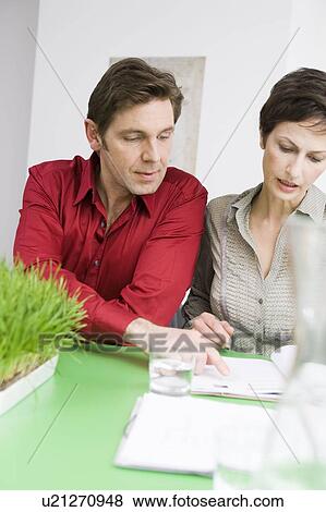 Man and woman discussing some paper View Large Photo Image Stock Photo - Man and woman discussing some paper. Fotosearch