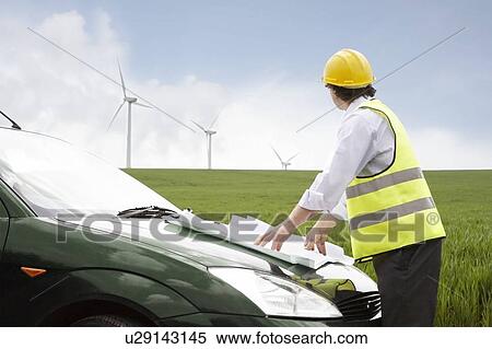 Man looking at wind turbines View Large Photo Image Stock Photography - Man looking at wind turbines. Fotosearch