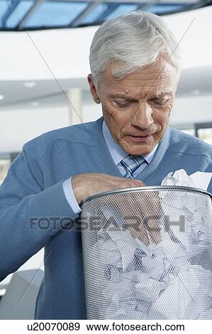 Mature businessman looking into bin View Large Photo Image Stock Photo - Mature businessman looking into bin. Fotosearch
