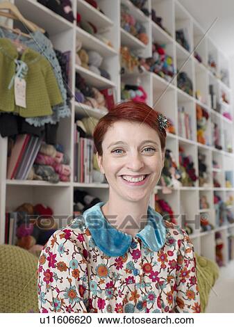 Woman sitting in craft shop, smiling, portrait, close-up View Large Photo Image Stock Image - Woman sitting in craft shop, smiling, portrait, close-up. Fotosearch