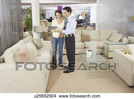 Woman talking to salesman in sofa shop. View Large Photo Image Picture - Woman talking to salesman in sofa shop.. Fotosearch