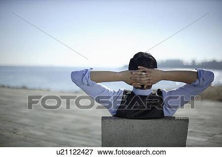Business man sitting by shoreline View Large Photo Image Stock Photo - Business man sitting by shoreline. Fotosearch