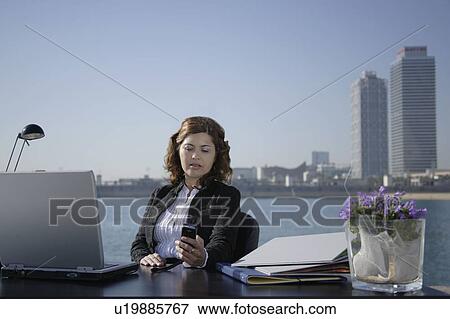 Stock Photo - Business woman in outdoor office. Fotosearch