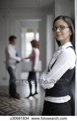 Business woman standing by window View Large Photo Image Picture - Business woman standing by window. Fotosearch