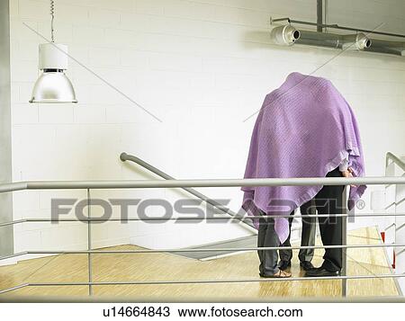 Stock Image - Businesspeople under a blanket. Fotosearch