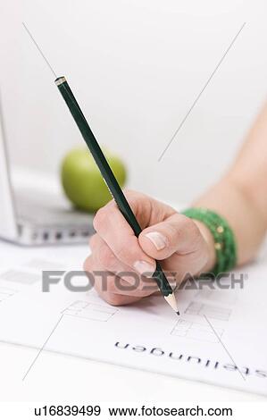 Stock Photo - Close up hand writing with a pencil. Fotosearch