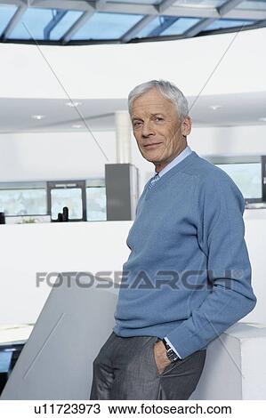 Man leaning against balustrade View Large Photo Image Stock Image - Man leaning against balustrade. Fotosearch