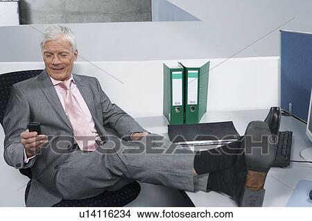 Picture - Man with feet on desk. Fotosearch
