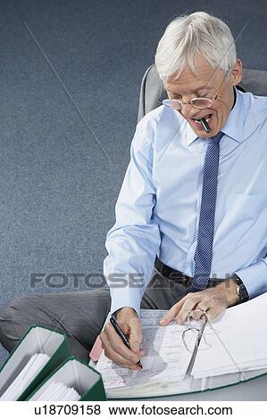 Stock Photo - Mature businessman writing. Fotosearch