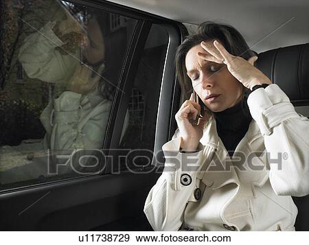 Stock Photo - Woman in car, on the phone. Fotosearch