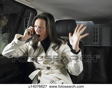 Woman in car, on the phone View Large Photo Image Stock Photo - Woman in car, on the phone. Fotosearch