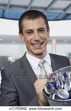 Young businessman with bin View Large Photo Image Stock Image - Young businessman with bin. Fotosearch