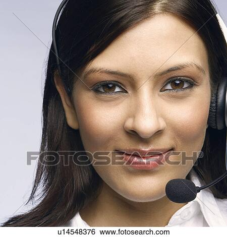 Stock Photograph - Close-up of a female customer service representative wearing a headset. Fotosearch