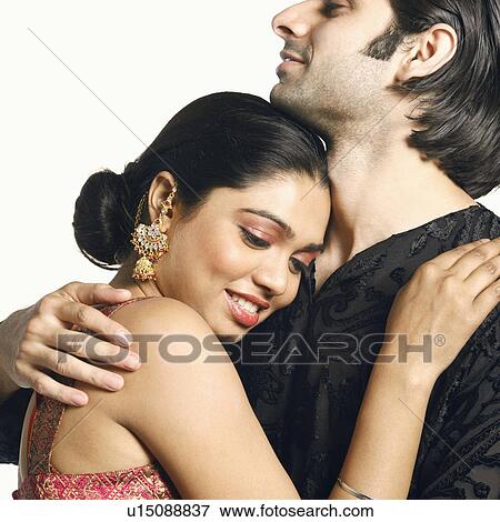 Close-up of a young man embracing a young woman View Large Photo Image Stock Photo - Close-up of a young man embracing a young woman. Fotosearch
