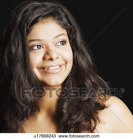 Close-up of a young woman smiling View Large Photo Image Stock Image - Close-up of a young woman smiling. Fotosearch