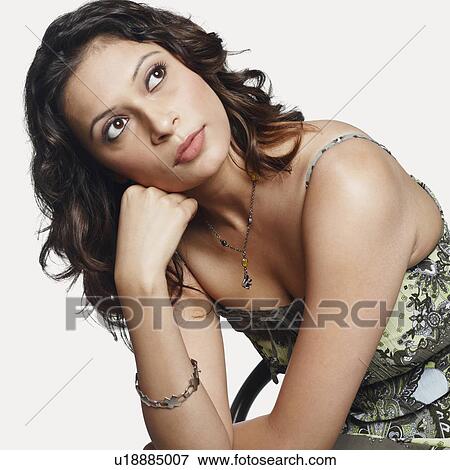 Stock Photo - Close-up of a young woman thinking. Fotosearch